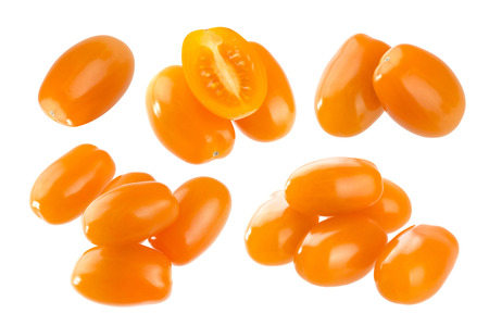 Heap of orange cherry tomatoes isolated on white backgroundの写真素材