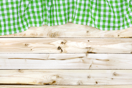 Green tablecloth on wooden table, top viewの写真素材