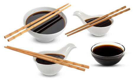 Soy sauce and chopsticks isolated on whiteの写真素材