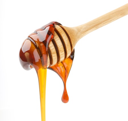 Honey stick isolated on whiteの写真素材