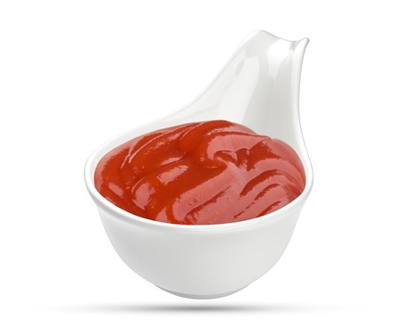 Ketchup in bowl isolated on white background. Portion of red tomato sauce. With clipping path.の写真素材