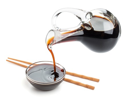Soy sauce and chopsticks isolated on white background, with clipping pathの写真素材