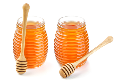 Honey in glass jar isolated on white background, with clipping pathの写真素材