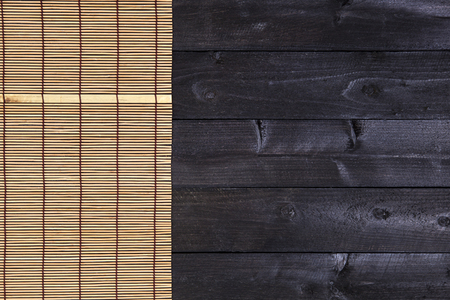 Bamboo mat on wooden table. Top view with copy spaceの写真素材