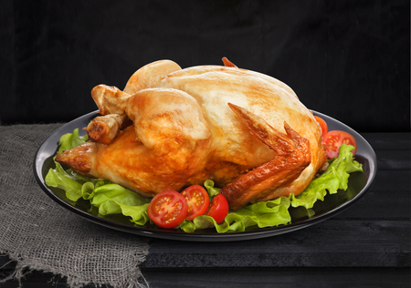 Roasted chicken on black backgroundの写真素材