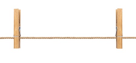 Isolated clothespins. Wooden clothespins on rope isolated on white background with clipping pathの写真素材