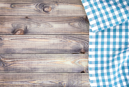 White old wooden table with blue checkered tablecloth, top view with copy spaceの写真素材