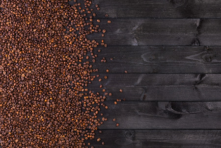Coffee beans on dark wooden background. Top view with copy spaceの写真素材
