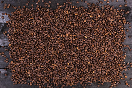 Frame of coffee beans on dark wooden background. Top view with copy spaceの写真素材