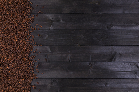Coffee beans on dark wooden background. Top view with copy spaceの写真素材