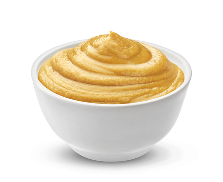 Mustard sauce in bowl isolated on white background. One of the collection of various saucesの写真素材