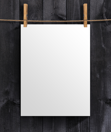 White blank poster template on a wooden background. Mock up for your project with copy spaceの写真素材