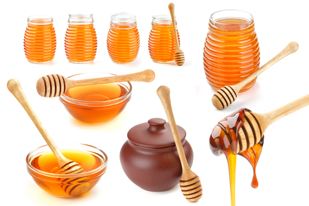 Isolated honey. Glass bowl, pot and honey stick isolated on white background with clipping pathの写真素材