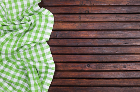 Green checkered tablecloth on dark wooden table with, top view with copy spaceの写真素材