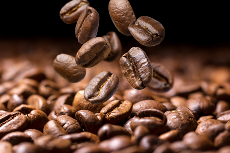 Falling coffee beans close-up, flying coffee beans over dark backgroundの写真素材