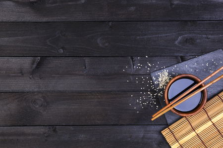 Sushi chopsticks and soy sauce on black background. Top view with copy space.の写真素材