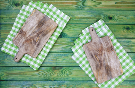 Cutting boards over green checkered tablecloths on the table, top viewの写真素材