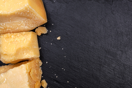 Parmesan on black background. Top view, copy space.の写真素材