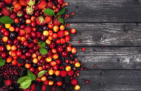 Fresh forest berries on rustic wooden background. Copy space, top viewの写真素材