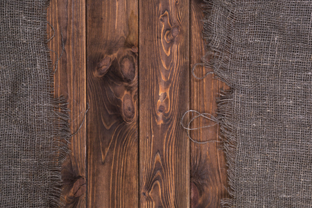 Burlap on dark wooden background, top viewの写真素材