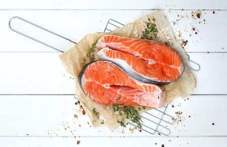 Salmon steak on white wooden table, top viewの写真素材