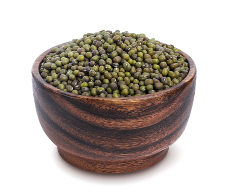 Green mung in wooden bowl isolated on white backgroundの写真素材