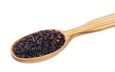 Black rice in wooden spoon isolated on white background. One of the collectionの写真素材