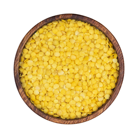 Yellow lentils in wooden bowl isolated on white background. Top viewの写真素材