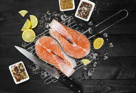 Salmon steak on black wooden table, top viewの写真素材