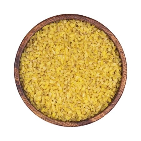 Bulgur wheat in plate isolated on white background, top view. One of the collectionの写真素材