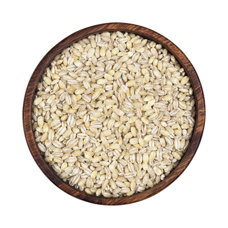 Pearl barley groats in wooden bowl isolated on white background, top viewの写真素材