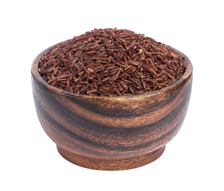 Red rice groats in wooden bowl isolated on white backgroundの写真素材