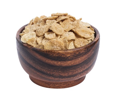 Corn flakes in wooden bowl isolated on white backgroundの写真素材