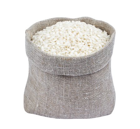 Risotto rice in burlap bag isolated on white backgroundの写真素材