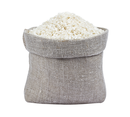Risotto rice in burlap bag isolated on whiteの写真素材
