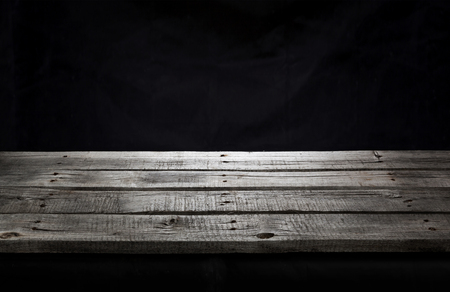 Black wooden table for product presentation, dark backgroundの写真素材