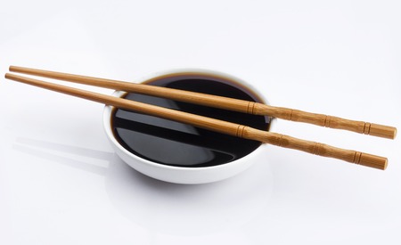 Soy sauce and chopsticks isolated on white background with clipping pathの写真素材