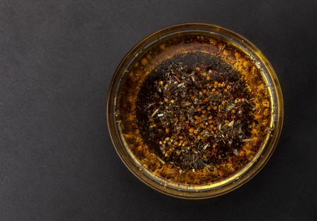 Oil salad dressing isolated on black background, top viewの写真素材