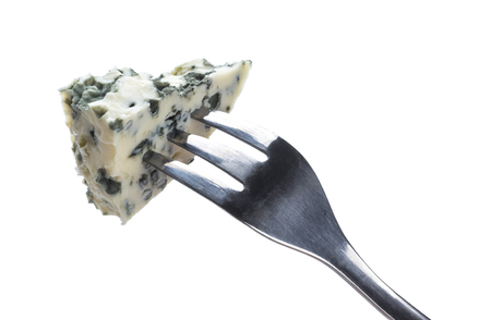 Danish blue cheese on fork isolated on white backgroundの写真素材