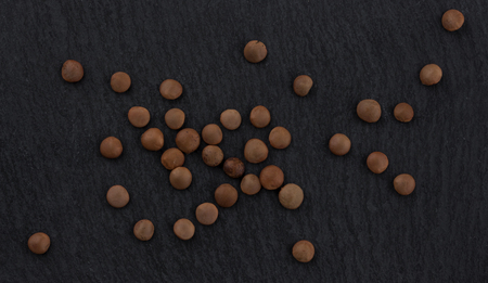 Lentils on black background. Top view