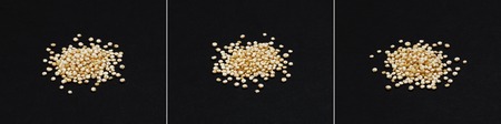 Quinoa seeds. Heap of healthy white quinoa grains isolated on black background, close-upの写真素材