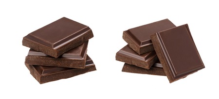 Dark chocolate bars isolated on white background. Stack of chocolate pieces, closeupの写真素材