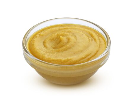 Mustard sauce in bowl isolated on white backgroundの写真素材