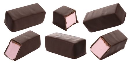 Chocolate candies with milk strawberry souffle, berry marshmallow filling bonbons isolated on white...