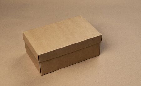 Brown cardboard box on craft paper background, product package mock upの写真素材