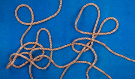 Ship rope on blue background, top view and copy space