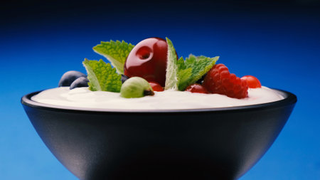 Bowl of yogurt with wild berries: strawberry, blueberry, raspberryの写真素材