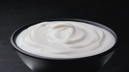 Bowl of sour cream on black backgroundの写真素材