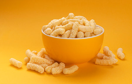 Sweet corn sticks isolated on yellow background