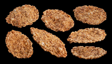 Bran flakes on black background, traditional breakfast cereal